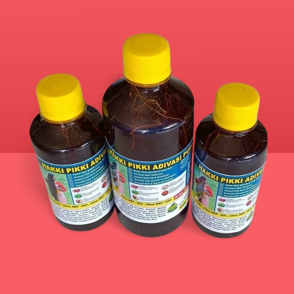 Three bottles of Hakki Pikki Adivasi Puja with yellow caps on a red background