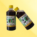 Two bottles of Hakkipikki hair oil on a yellow background