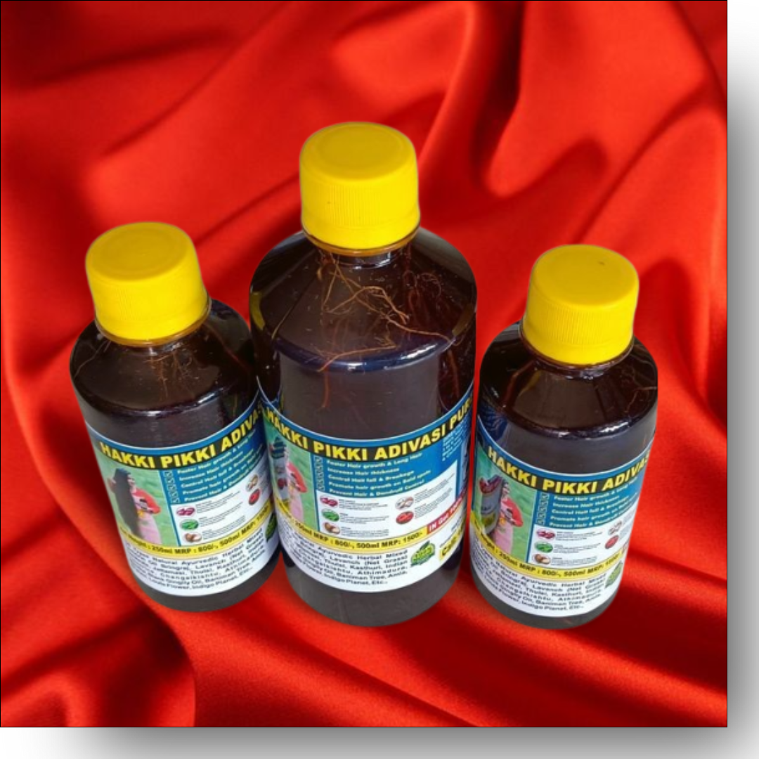 Three bottles of 'Hakki Pikki Adivasi' on a red fabric background
