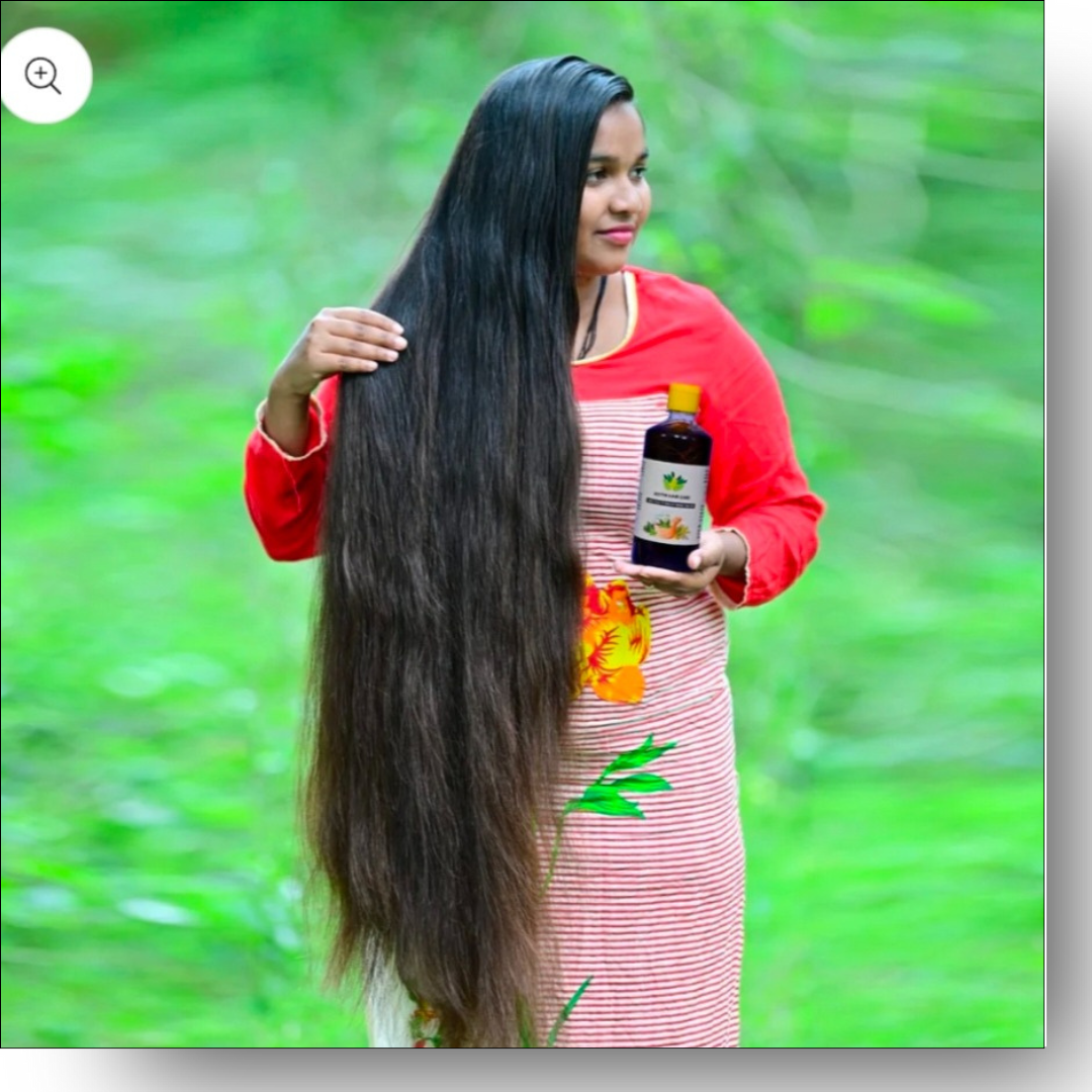 Two bottles of Hakki Pikki Hair Oil with green leaves on a wooden surface and green background.